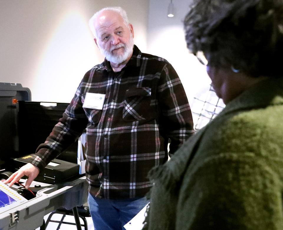 David Ussery shows Emma North the new voting machine as he sets it up and goes over the new procedure during early voting at Middle Tennessee Association of Realtors on Wednesday, Feb. 21, 2024.