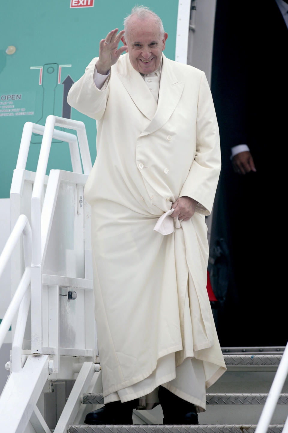 Pope Francis waves as he disembarks from an airplane at Knock's airport, Ireland, where he will visit the Knock Shrine and recite an angelus prayer, Sunday, Aug. 26, 2018. Pope Francis is on a two-day visit to Ireland. (Yui Mok/PA via AP)