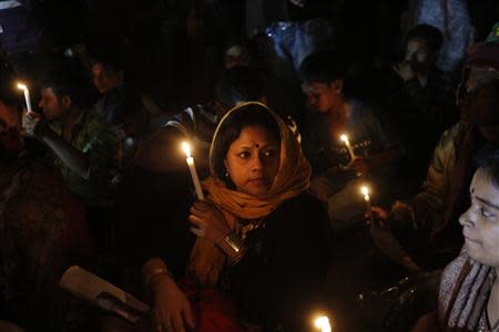 People hold candles as they attend a sit-in protest at Shahbagh intersection demanding capital punishment for Bangladesh's Jamaat-e-Islami senior leader Abdul Quader Mollah after he won a dramatic stay of execution before he was due to be hanged in Dhaka December 10, 2013. MollahREUTERS/Andrew Biraj