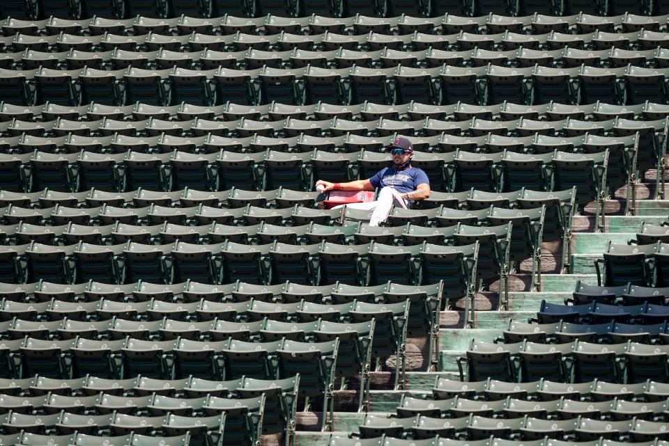 Boston Red Sox first baseman Michael Chavis (23) sits next to a red seat memorializing the longest home run hit at Fenway Park by Ted Williams in 1946 during practice on July 5, 2020.