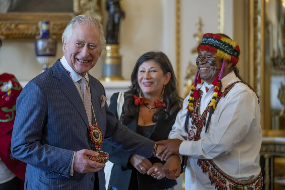 Amazon Indigenous leader Domingo Peas (right), presents a gift to King Charles III during a reception to discuss the practical delivery of the global biodiversity framework at Buckingham Palace, Londo (PA)