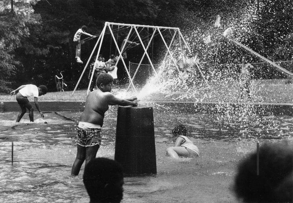 Black festival, etc. at Chickasaw Park. June 21, 1980. Photo by Robert SteinauAt the wading pool, Jamie Hodgens (9) makes his own shower.