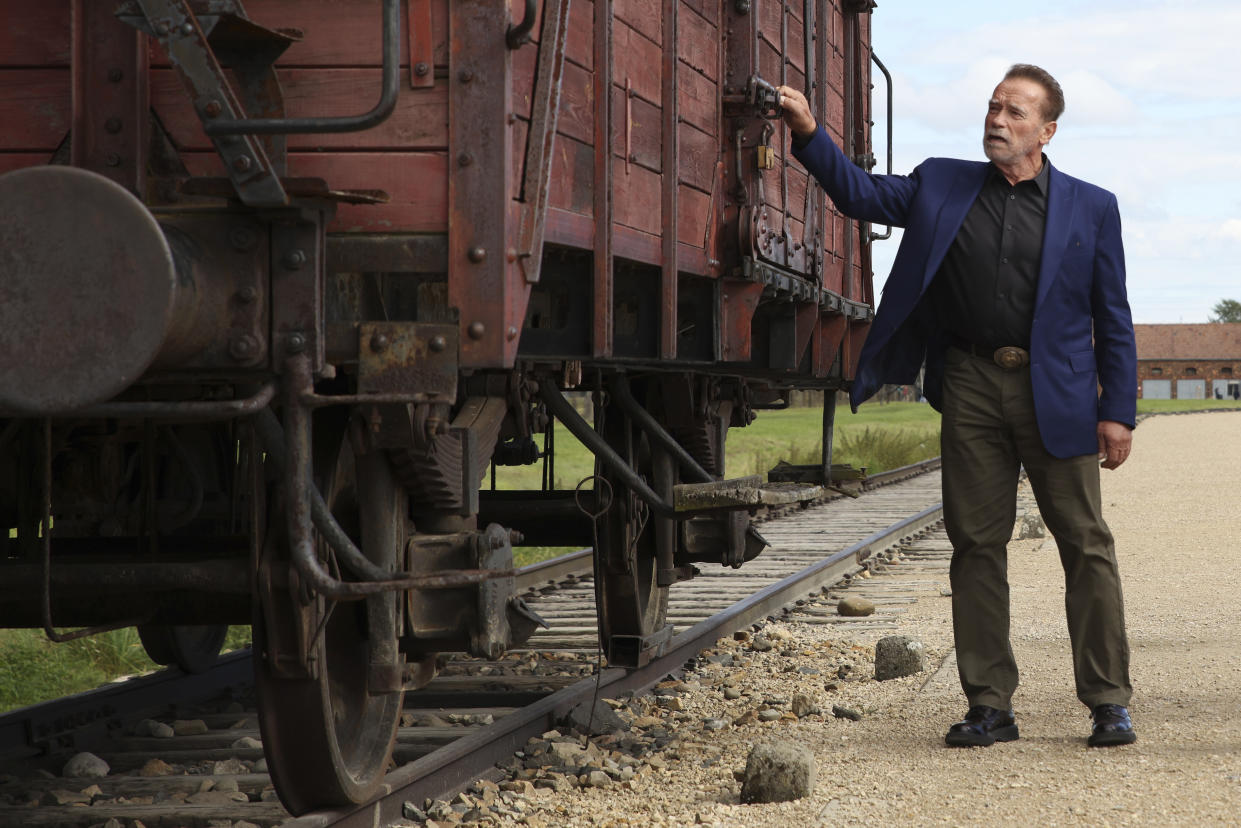 Arnold Schwarzenegger visits Auschwitz - Birkenau Nazi German death camp in Oswiecim, Poland, Wednesday, Sept. 28, 2022. Film icon Arnold Schwarzenegger visited the site of the Nazi German death camp Auschwitz on Wednesday to send a message against hatred. The "Terminator" actor was given a tour of the site, viewing the barracks watchtowers and the remains of gas chambers that endure as evidence of the German extermination of Jews, Roma and others during World War II. (AP Photo/Michal Dyjuk)