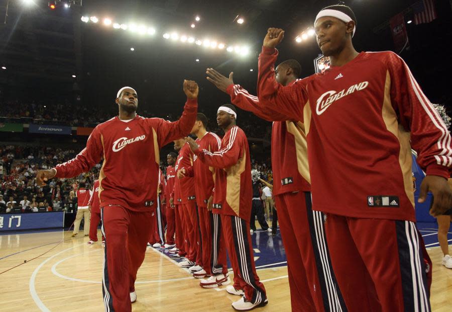 LeBron James of Cleveland Cavaliers gives a high five to teammates before their NBA pre-season match against Orlando Magic at the Venetian Macao in Macau, 20 October 2007. Orlando Magic won 100-84 AFP (Photo credit: TED ALJIBE/AFP/Getty Images)