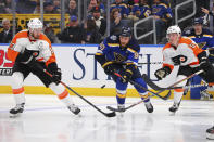 Philadelphia Flyers center Kevin Hayes (13) and center Philippe Myers (5) defend against St. Louis Blues center Ryan O'Reilly (90) during the second period of an NHL hockey game Wednesday, Jan. 15, 2020 in St. Louis. (AP Photo/Dilip Vishwanat)