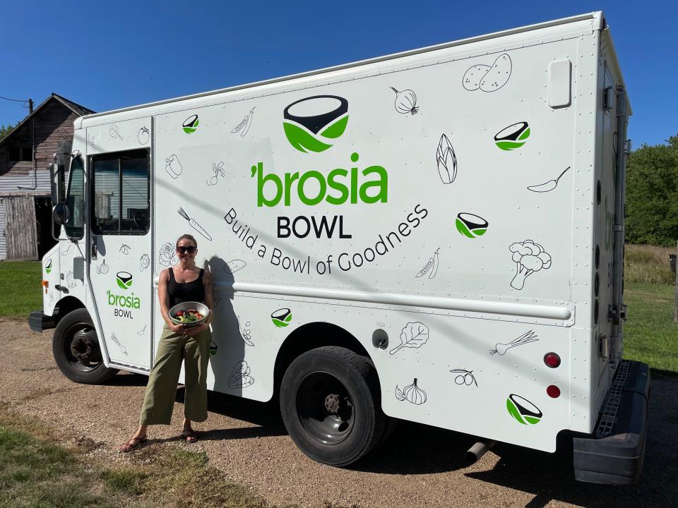 Darcy Green, owner of 'Brosia Bowl, poses in front of her food truck. 'Brosia Bowl features food like grain bowls, salads and wraps as well as breakfast sandwiches and burritos.