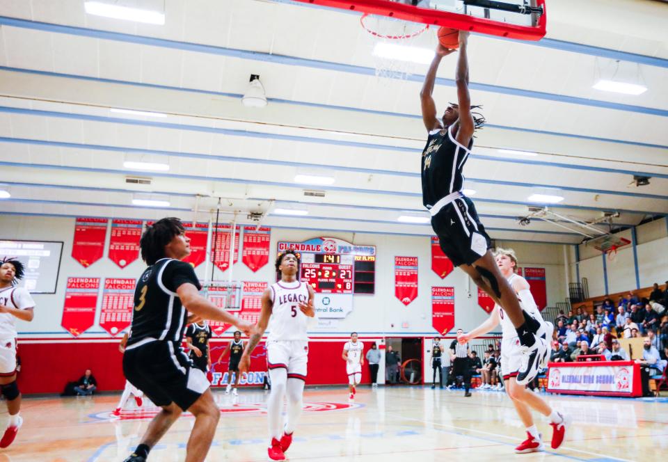 Jacolb Cole, of Link Academy, dunks the ball during a game against the Legacy (Texas) Broncos in the Ozark Mountain Shootout at Glendale High School on Thursday, Dec. 8, 2022.