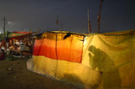 A Hindu pilgrim prays during Magh Mela festival, in Prayagraj, India. Tuesday, Feb. 16, 2021. Millions of people have joined a 45-day long Hindu bathing festival in this northern Indian city, where devotees take a holy dip at Sangam, the sacred confluence of the rivers Ganga, Yamuna and the mythical Saraswati. Here, they bathe on certain days considered to be auspicious in the belief that they be cleansed of all sins. (AP Photo/Rajesh Kumar Singh)