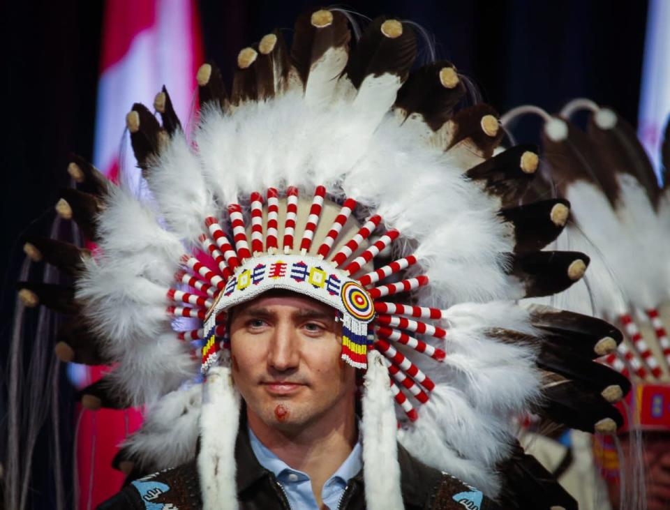 Prime Minister Justin Trudeau poses after receiving a ceremonial headdress while visiting the Tsuut'ina First Nation near Calgary, Alta., Friday, March 4, 2016. THE CANADIAN PRESS/Jeff McIntosh