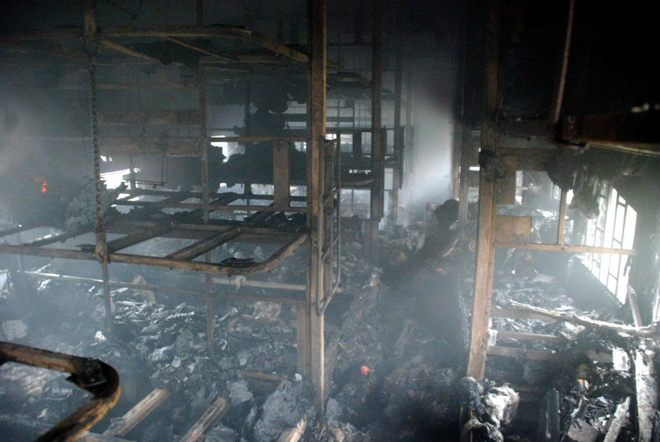 A totally charred coach from inside is seen of a passenger train at Nellor nearly 500 kilometers (310 miles) south of Hyderabad, India, Monday, July 30, 2012. A fire swept through a train car packed with sleeping passengers in southern India on Monday, killing at least 47 people and sending panicked survivors rushing for the only clear exit once the train stopped, officials said. (AP Photo)