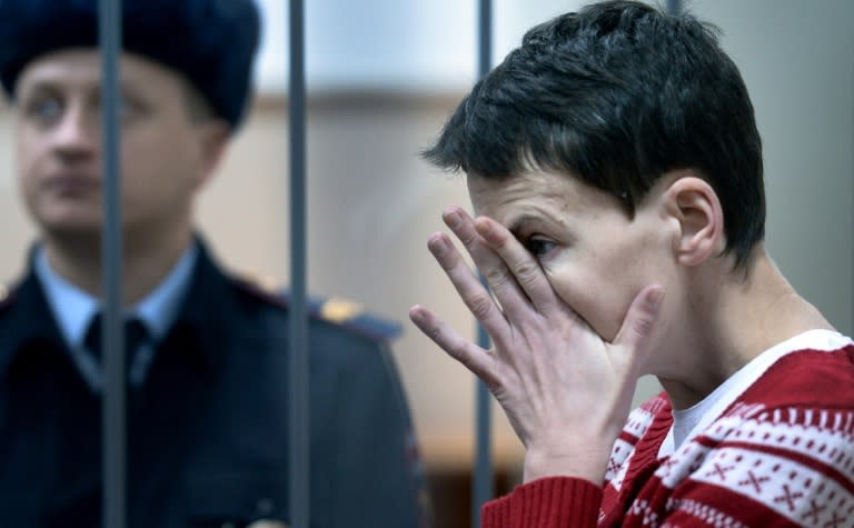 Ukrainian airforce helicopter navigator Nadezhda (Nadiya) Savchenko, 34, reacting inside a defendants' cage as she attends a hearing at the Basmanny district court in Moscow