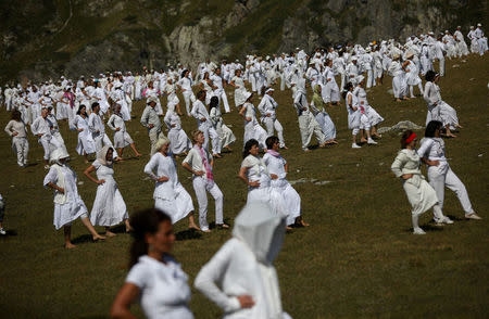 Followers of the Universal White Brotherhood, an esoteric society that combines Christianity and Indian mysticism set up by Bulgarian Peter Deunov in the 1920s, perform a dance-like ritual called "paneurhythmy" in Rila Mountain, Bulgaria, August 19, 2017. REUTERS/Stoyan Nenov