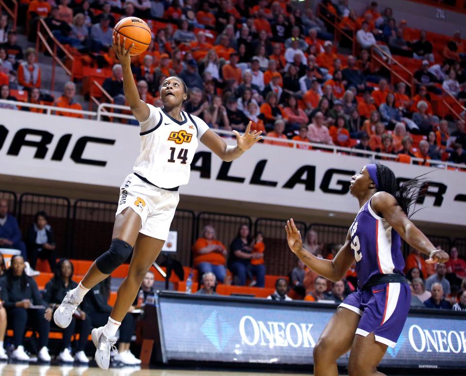 Oklahoma State's Taylen Collins (14) goes up for a lay up as TCU's Tara Manumaleuga (2) defends in the first half during the college women's basketball game between the Oklahoma State Cowgirls and the TCU Horned Frogs at Gallagher-Iba Arena in Stillwater, Okla., Saturday, Jan.14, 2023. 