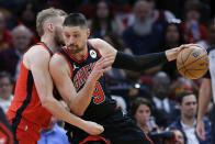 Chicago Bulls center Nikola Vucevic (9) drives into Houston Rockets center Jock Landale, left, during the first half of an NBA basketball game Thursday, March 21, 2024, in Houston. (AP Photo/Michael Wyke)
