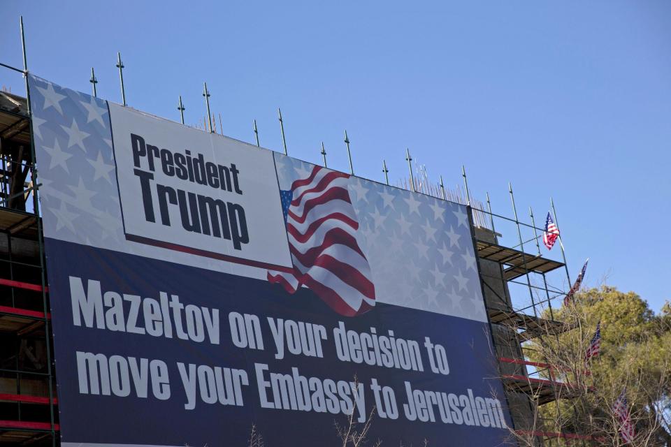 FILE -- In this Jan. 20, 2017 file photo, a sign hangs on a building under construction in Jerusalem congratulating U.S. President Donald Trump, who has vowed to move the U.S. embassy from Tel Aviv to more controversial Jerusalem. The Trump administration appears to be easing away from longstanding U.S. support for Palestinian statehood as the preferred outcome of Middle East peace efforts, which may please some allies of Prime Minister Benjamin Netanyahu in Israel. But the alternatives are few, and each comes with daunting and combustible complications, including for Israel itself. (AP Photo/Ariel Schalit, File)