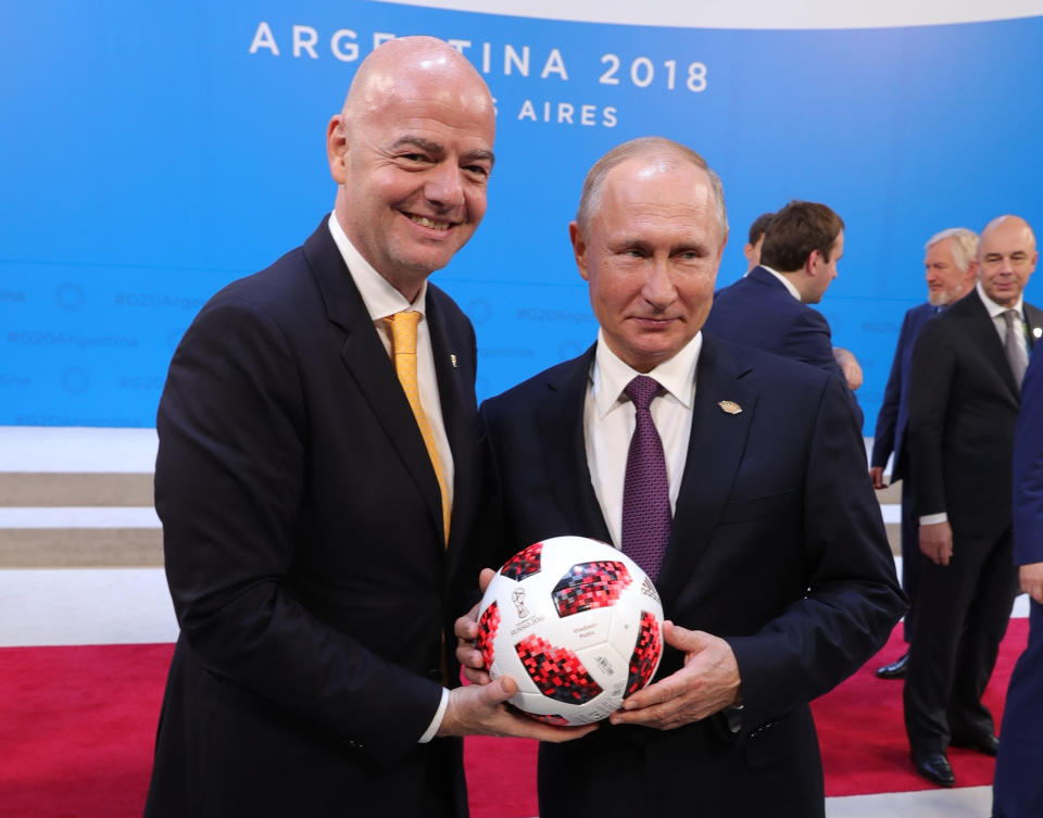 FILE In this file photo taken on Friday, Dec. 28, 2018, Russian President Vladimir Putin, right, and FIFA President Gianni Infantino pose for a photo at the G20 summit in Buenos Aires, Argentina. Putin may look like a winner after an abrupt U.S. decision to pull out of Syria, but the Russian leader faces massive challenges in Syria and elsewhere, and he hasn't moved an inch closer to the lifting of Western sanctions that have emaciated the national economy. (Mikhail Klimentyev, Sputnik, Kremlin Pool Photo via AP, File)