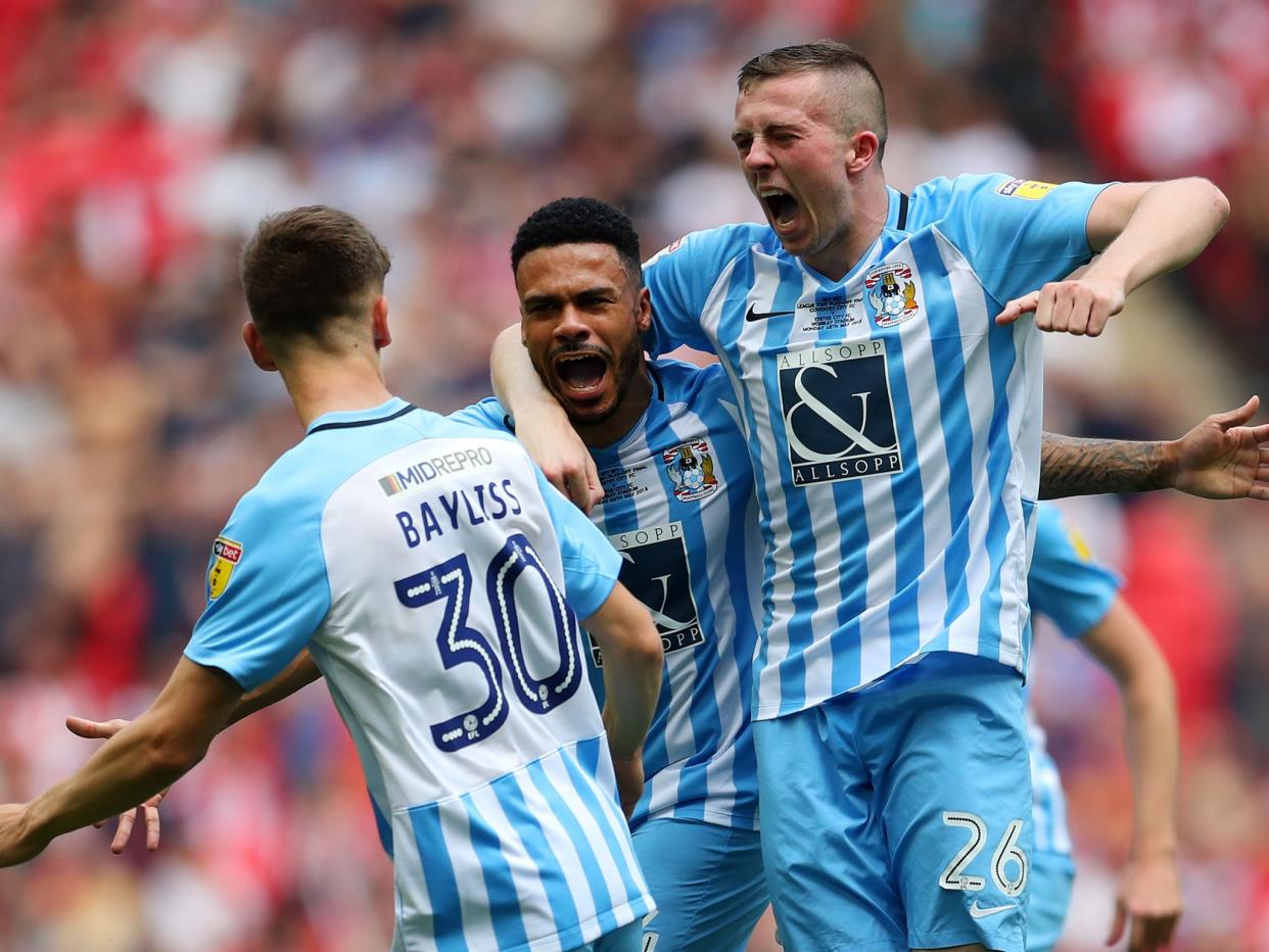 Jordan Willis celebrates with his Coventry team mates after scoring his side's first goal: Getty