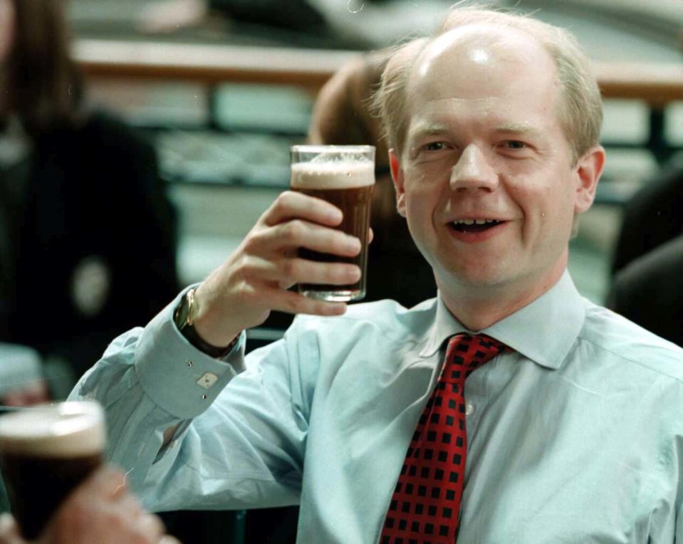 Conservative Party leader William Hague enjoys a half pint of Guinness during his visit to the Castlecourt shopping mall in Belfast City Centre. 8/6/01: Hague dramatically announced that he was to quit as Tory leader after his party's heavy election defeat.   * In a keenly awaited statement outside Conservative Central Office, Hague said he would step down as leader of the party when a successor can be elected.  Mr Portillo is likely to be one of the contenders for the position.   * 08/08/00 William Hague has revealed to GQ magazine that he used to drink up to 14 pints of beer a day when he was a teenager. As a schoolboy, the future Tory leader had a holiday job delivering soft drinks and beer to working men's clubs in South Yorkshire for his father's business, Hague's Soft Drinks.  He told the magazne that, as the driver's mate, he used to have a pint at every stop.   (Photo by Brian Little - PA Images/PA Images via Getty Images)