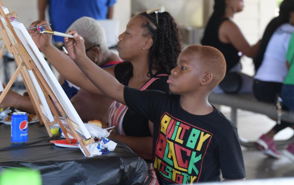 Chase Reed, 8, paints during the NFBPA South Florida Juneteenth Paint and Reflection held at Intracoastal Park in Boynton Beach Monday, June 20, 2022. The event was presented by the National Forum for Black Public Administrators & National Black MBA Association and featured food and painting activities that included a 16-by-20-inch canvas with an outline of the picture, easel, paint brushes, paint and two hours of instruction.