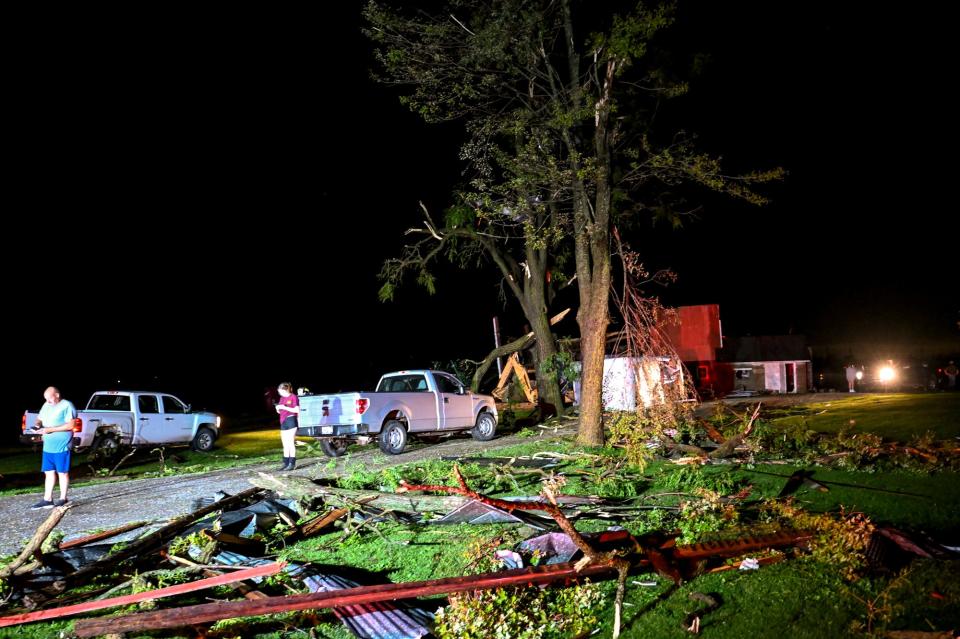 Debris and tree limbs are scattered across the lawn of a home damaged during a storm on Thursday, Aug. 24, 2023, south of I-96 and east of Williamston.
