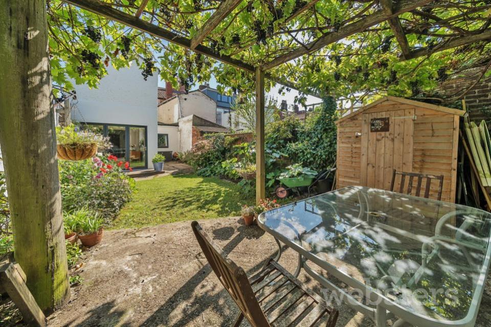 Eastern Daily Press: A raised patio with a pergola overlooks the rear garden