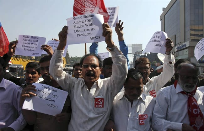 Left Party activists hold placard and shout slogans during a protest against the alleged mistreatment of New York based Indian diplomat Devyani Khobragade, near the U.S Consulate in Hyderabad, India, Thursday, Dec. 19, 2013. The case has sparked a diplomatic firestorm between the United States and India, which is outraged over what it described as degrading treatment toward Khobragade, India's deputy consul general in New York. (AP Photo/Mahesh Kumar A.)