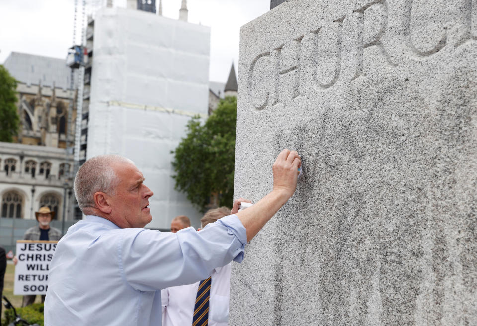 Lee Anderson MP cleans graffiti from the statue of Winston Churchill at Parliament Square, in the aftermath of protests against the death of George Floyd who died in police custody in Minneapolis, London, Britain, June 8, 2020. REUTERS/John Sibley