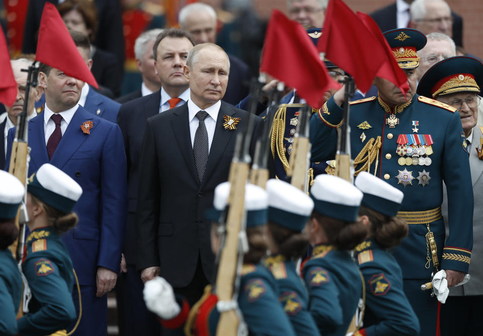 Russian President Vladimir Putin, center, Russian Prime Minister Dmitry Medvedev, left, and Russian Defense Minister Sergei Shoigu, right, attend a wreath-laying ceremony at the Tomb of the Unknown Soldier after the military parade marking 74 years since the victory in WWII in Moscow, Russia, Thursday, May 9, 2019. (AP Photo/Pavel Golovkin)