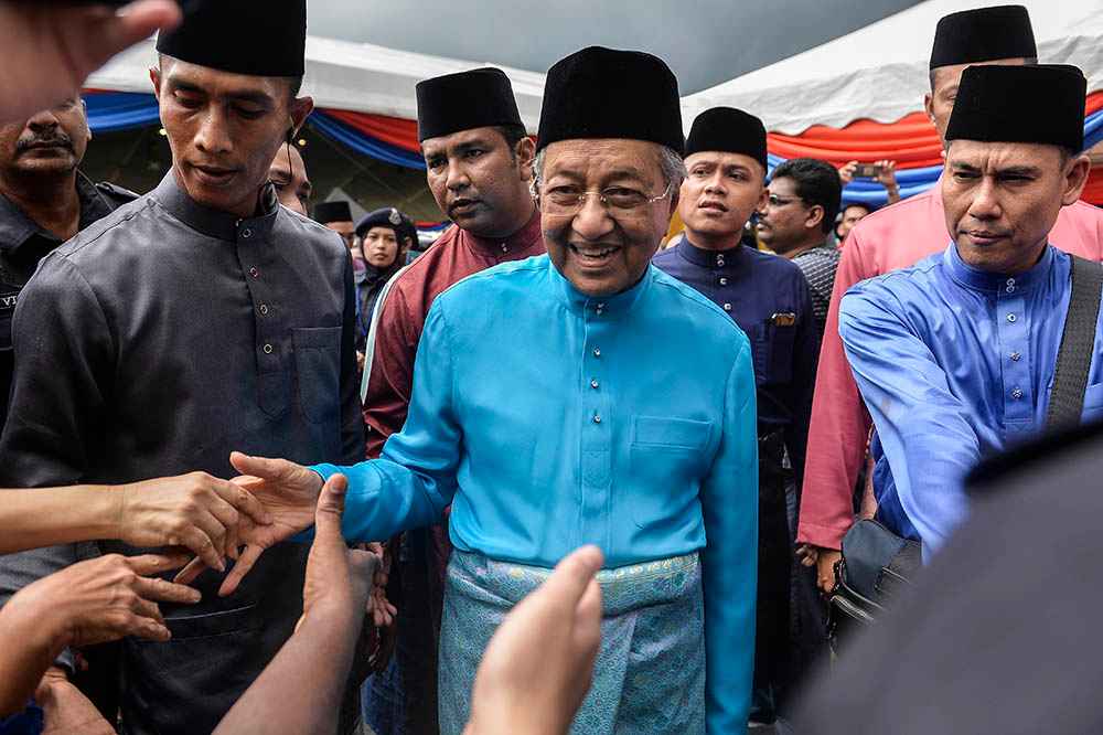 Prime Minister Tun Dr Mahathir Mohamad greeting visitors to his Raya Open House at Seri Perdana, Putrajaya June 5, 2019. — Picture by Miera Zulyana