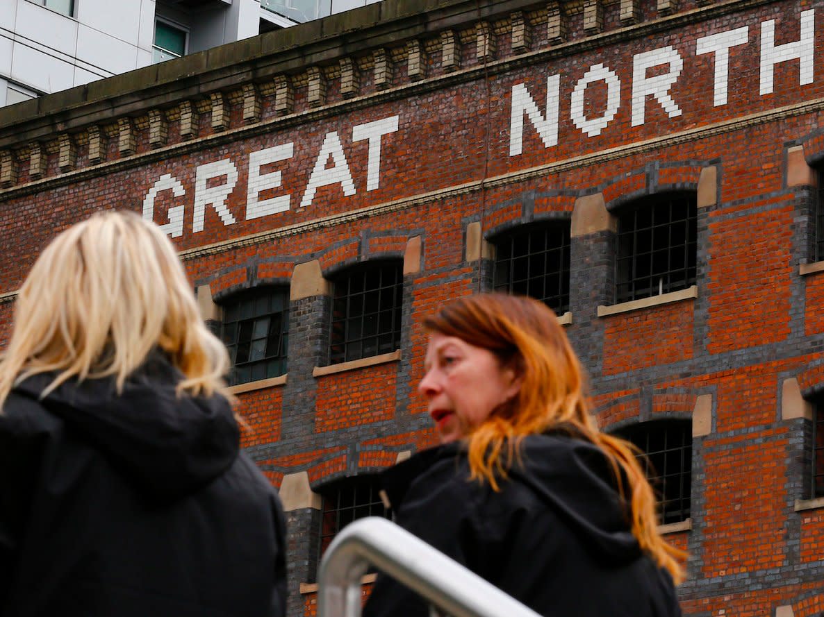 Women walk through Manchester city centre, Britain May 14, 2015. British Chancellor George Osborne offered on Thursday to hand over new powers to cities in what he called a