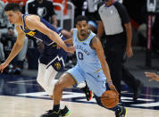 Memphis Grizzlies guard De'Anthony Melton, right, picks up the ball as Denver Nuggets forward Michael Porter Jr. pursues in the first half of an NBA basketball game Monday, April 19, 2021, in Denver. (AP Photo/David Zalubowski)