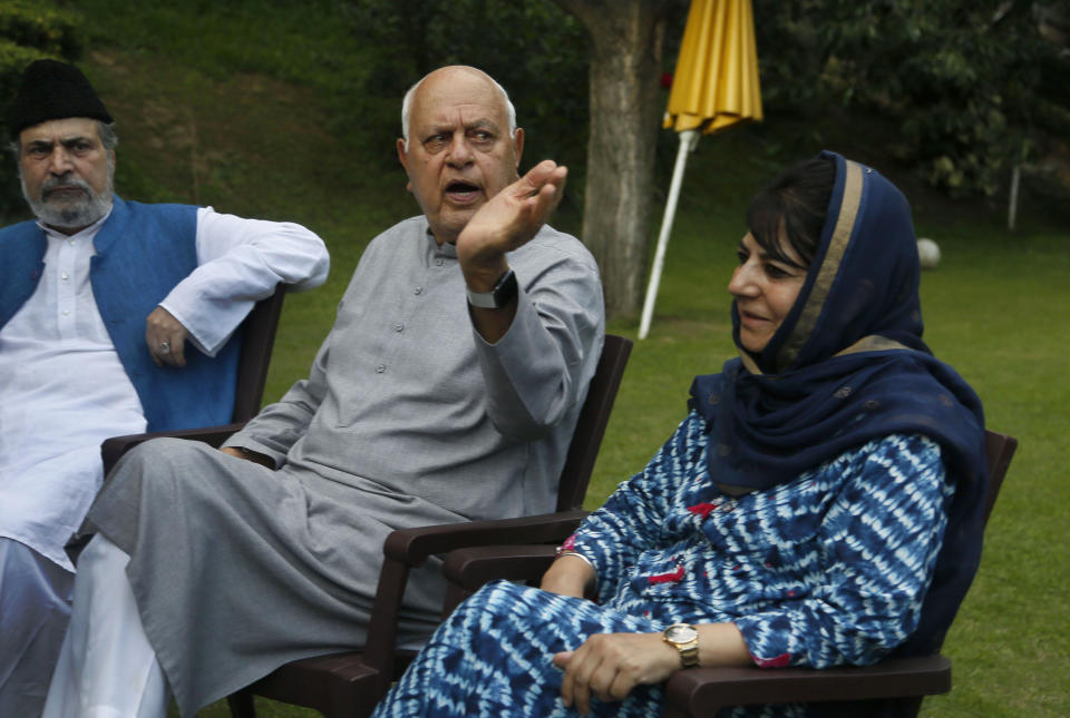 FILE - In this Aug. 4, 2019, file photo, National Conference president Farooq Abdullah, center, gestures during an all parties meeting in Srinagar, Indian controlled Kashmir. Abdullah, 81, also the former chief minister of Jammu and Kashmir, was arrested Monday under the Public Safety Act at his residence in Srinagar, the summer capital of the disputed region. (AP Photo/Mukhtar Khan, File)