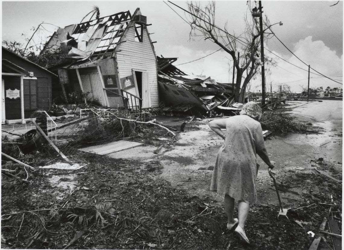 In this file photo from Aug. 24, 1992, Hazel Mueller walked along Southwest 224th Street in the Cauley Square village in Goulds just after Hurricane Andrew descended on South Miami-Dade. Most of the shops were heavily damaged and much of the main building’s second floor had to be demolished before restoration work began after the hurricane.