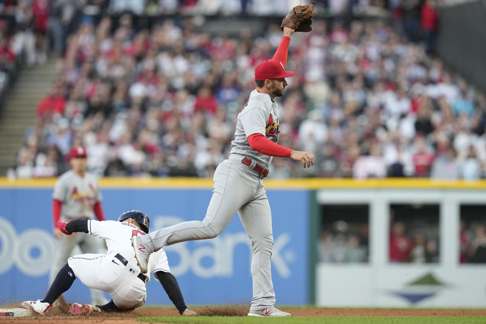 St. Louis Cardinals shortstop Paul DeJong takes the throw from right fielder Brendan Donovan on a single by Cleveland Guardians' Mike Zunino as Andrés Giménez, left, advances to second base during the fifth inning of a baseball game Friday, May 26, 2023, in Cleveland. (AP Photo/Sue Ogrocki)