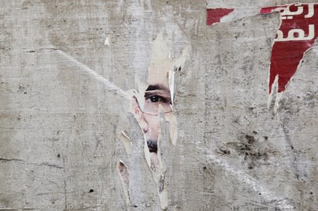 FILE PHOTO - Remnants of a poster of ousted Egyptian President Mursi are pictured on a wall on a street in Cairo