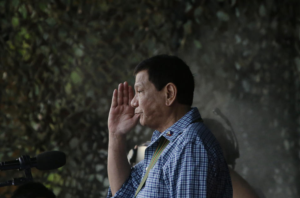 FILE - In this Wednesday Dec. 13, 2018, file photo Philippine President Rodrigo Duterte salutes to soldiers during a ceremony to destroy hundreds of guns and weapons confiscated from pro-Islamic State group siege in Marawi, southern Philippines at the Philippine Army Headquarters in Manila, Philippines. International Criminal Court judges on Wednesday Sept. 15, 2021, authorized an investigation into the Philippines' deadly "war on drugs" campaign, saying the crackdown "cannot be seen as a legitimate law enforcement operation." (AP Photo/Aaron Favila)