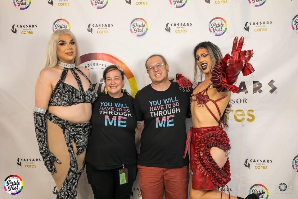 Britt Leroux and her husband John Reh (centre) pose with drag performers during a Windsor-Essex Pride Fest event.