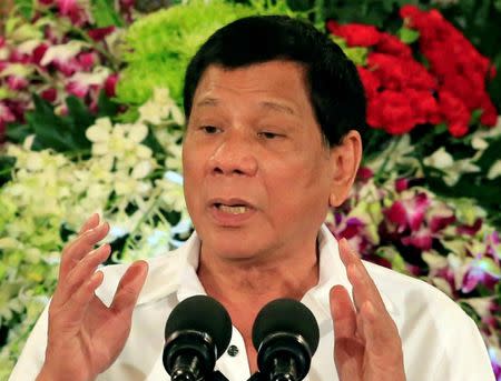 Philippine President Rodrigo Duterte gesture as he addresses Filipino-Muslim leaders during an Eid al-Fitr celebration at the Malacanang Presidential Palace in Metro Manila, Philippines June 27, 2017. REUTERS/Romeo Ranoco