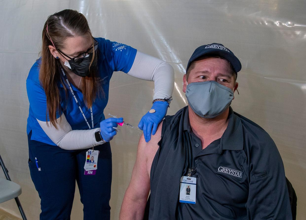 WORCESTER - Nurse Bethany Morrill gives Jim Godfrey of Grafton his booster Covid-19 vaccination shot at Mercantile Center Tuesday, November 23, 2021. 