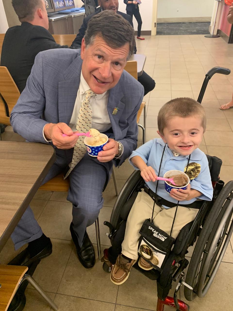 Former Wolfson Children's Hospital President Michael Aubin visits with Gage Spurlock, who has a genetic condition known as brittle bone disease and is a children's health care advocate.