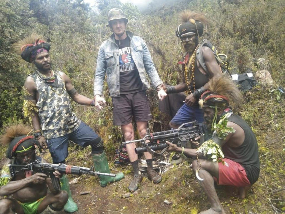 In this undated photo released by West Papua Liberation Army, the armed wing of the Free Papua Movement, Papuan separatist rebels pose for a photo with a man they said is New Zealander pilot Phillip Mark Mehrtens who they took hostage last week, at an undisclosed location in Papua province, Indonesia. Mehrtens, a pilot for Indonesian aviation company Susi Air, was abducted by the independence fighters who stormed his single-engine plane shortly after it landed on a small runway in Paro in remote Nduga district. (West Papua Liberation Army via AP)