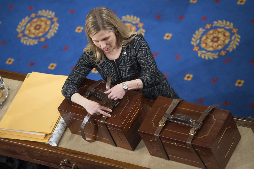 An aide opens Electoral College ballot boxes during a joint session of Congress to tally ballots for the president and vice president of the United States in January 2017. (Photo: Tom Williams via Getty Images)