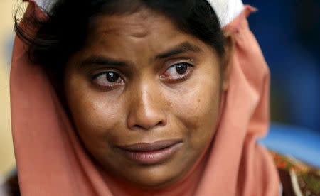 A Rohingya woman cries as her child is treated for malnutrition by a Malaysian medical team a day after they landed at Pantai Pasir Berdengung beach in Langkawi island, in the Malaysia's northern state of Kedah, Malaysia, May 12, 2015. REUTERS/Olivia Harris