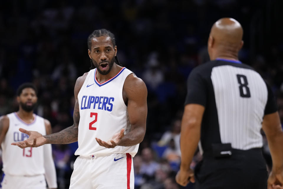 ORLANDO, FLORIDA - MARCH 29: Kawhi Leonard #2 of the LA Clippers speaks to referee Marc Davis #8 after being called for a foul during a game against the Orlando Magic at Kia Center on March 29, 2024 in Orlando, Florida. NOTE TO USER: User expressly acknowledges and agrees that, by downloading and or using this photograph, User is consenting to the terms and conditions of the Getty Images License Agreement. (Photo by Rich Storry/Getty Images)