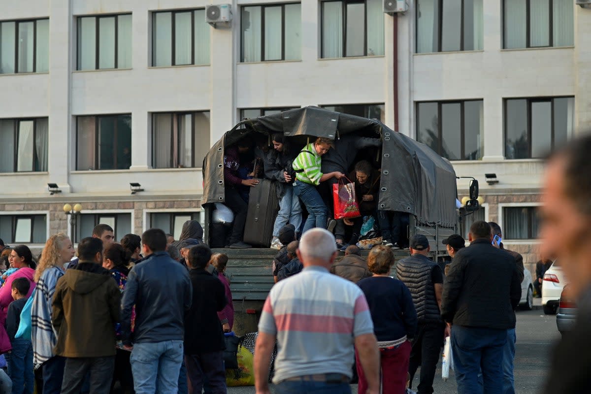 Residents board a vehicle in central Stepanakert before leaving Nagorno-Karabakh (REUTERS)