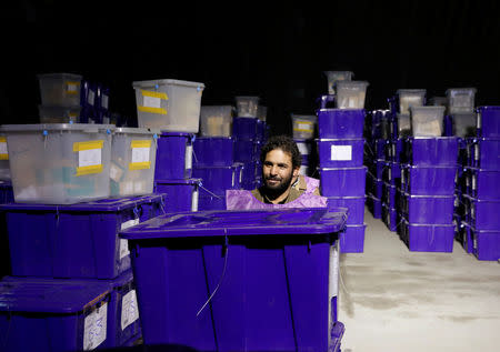 An Afghan election commission worker prepares ballot boxes and election material in a warehouse in Kabul, Afghanistan October 18, 2018.REUTERS/Mohammad Ismail