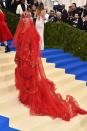 The singer arrived in a custom red Maison Margiela ensemble by John Galliano with a dramatic veil.