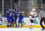 Sweden players celebrate a goal against Switzerland during the third period of an IIHF world junior hockey championships game in Edmonton, Alberta on Wednesday, Aug. 10, 2022. (Jason Franson/The Canadian Press via AP)