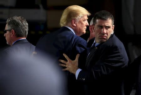 Secret Service agents surround Donald Trump during a disturbance at Dayton International Airport in Dayton, Ohio, March 12, 2016. REUTERS/Aaron P. Bernstein