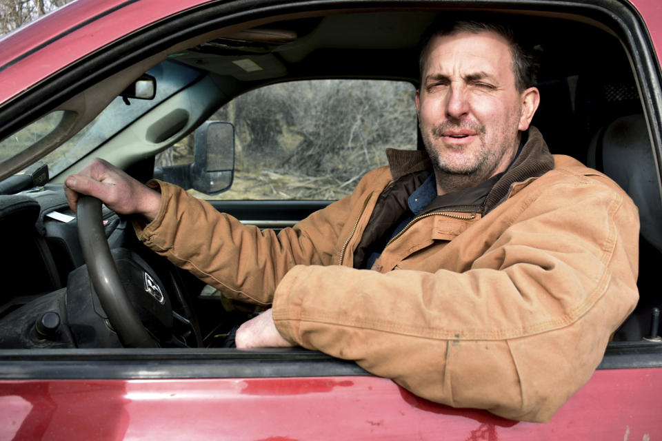 Cattle rancher Michael Miller drives his truck on his family's land near the Musselshell River, Tuesday, Feb. 7, 2023, near Harlowton, Mont. After a suspected Chinese spy balloon flew over the U.S. the week before, lawmakers in at least 11 statehouses and Congress are weighing further restrictions on foreign ownership of U.S. farmland. (AP Photo/Matthew Brown)